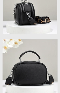 Detailed view of black pebbled leather crossbody bag with three zipper compartments