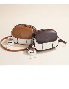 Two-tone crossbody square bags with dual zipper compartments and plush monster charm