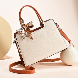 Elegant cream white faux crocodile leather handbag with orange handles and silk scarf detail