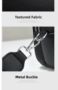 Close-up of black litchi pattern leather texture and silver metal detachable hook