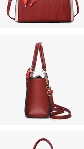 Detailed macro view of burgundy handbag featuring vertical wavy texture and pink trim