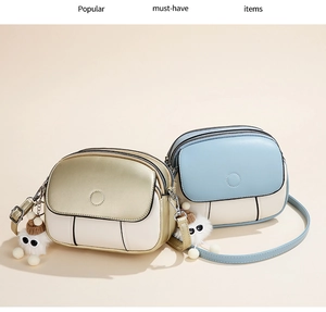 Detail of trendy color-block mini shoulder bags with plush charms and dual zipper closures