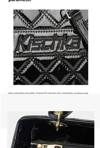 Detail of black quilted patent PU leather bag with embroidery and gold hardware