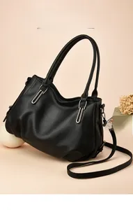 Close-up of black litchi grain PU leather handbag with silver hardware and shoulder strap