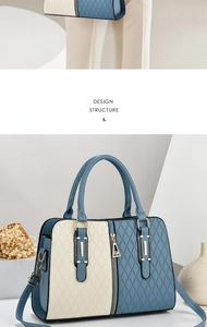 Detail of color-block tote bag with quilted pattern, gold hardware and blue leather panels