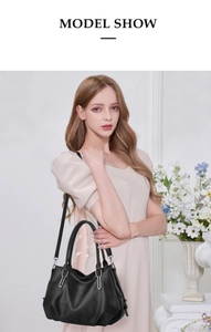 Model show of a black lychee texture PU leather handbag with silver metal buckle detail