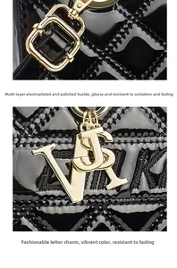 Detailed macro view of gold-plated metal lock and trendy letter pendants on quilted bag