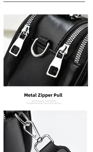 Detail of silver-tone hardware and high-quality black leather texture on hand bag