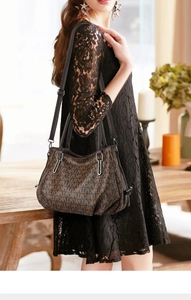 Detailed view of dark brown PU leather tote with monogram pattern and black handle