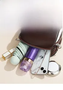 Detailed interior view showing high-capacity compartments and storage of a crossbody bag