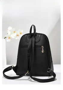 Detail view of black lychee grain leather backpack with back zipper and adjustable straps