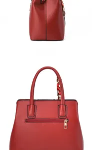 Detail of red leather handbag back zipper pocket and silk scarf handle decoration