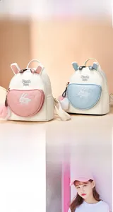 Detail of rabbit ear decor and embroidery on the soft PU leather mini backpack