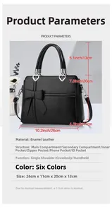 Detail of black bow handbag showing heart hardware and internal compartments layout