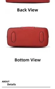 Detail view of the red leather handbag featuring reinforced bottom studs and clean stitching