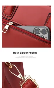 Detail of burgundy leather handbag showing rear zipper pocket and gold swivel hook
