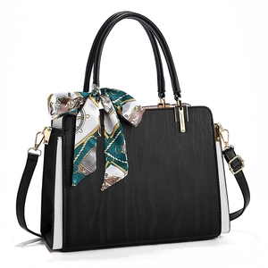 Elegant black and white contrast handbag with wave texture and decorative silk scarf
