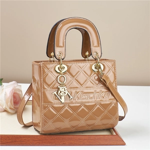 Glossy caramel quilted patent leather handbag with metal charms and top handles