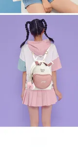 Detail of white PU leather backpack with pink heart pocket and cute bunny ears