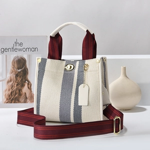 Large canvas tote bag with grey vertical stripes and burgundy webbing shoulder straps
