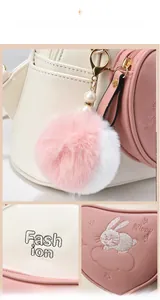 Detail of pink and white backpack with cute bunny embroidery and soft pompom charm
