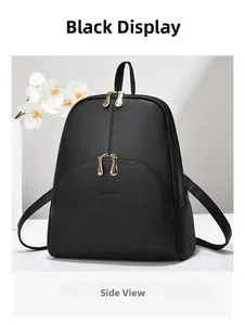 Close-up of black litchi grain backpack with gold zippers and JANENOVO brand logo