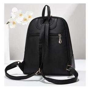 Rear view of black pebble leather backpack featuring gold hardware and anti-theft zipper pocket