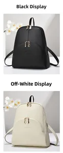 Detail of lychee textured backpacks in black and beige with dual metal zippers
