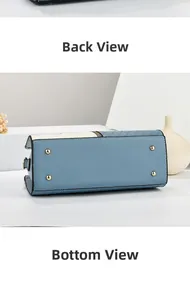 Detailed bottom view of a blue leather handbag showing gold protective metal feet and texture