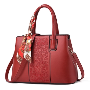 Elegant red faux leather handbag for women featuring intricate embroidery and silk scarf