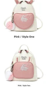 Detail view of two rabbit-themed backpacks with heart pockets and cute bunny ears design