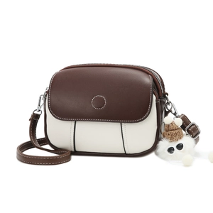 Contrast color crossbody bag with dual zippers and a cute plush doll charm pendant