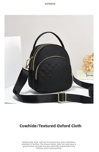 Detail of black oxford fabric cross-body bag with diamond stitching and gold hardware