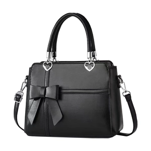 Classic black leather handbag with elegant bow decoration and silver heart-shaped buckles