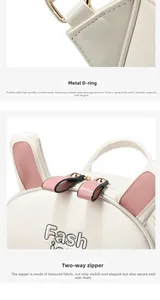 Detail of white leather backpack with gold metal D-ring, pink ears, and dual zippers