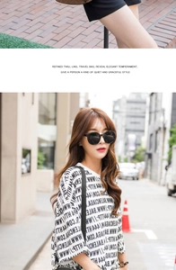 Close-up of white oversized T-shirt with black letter print and urban sunglasses