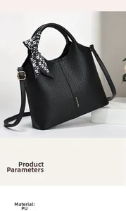 Close-up of black litchi pattern PU leather handbag with decorative checkered ribbon