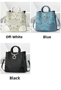 Close-up of hexagonal metal buckle and wave pattern embroidery on crossbody bag