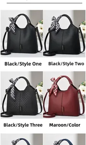 Detail view of stylish tote bags in black and burgundy with decorative handle scarves