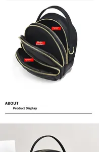 Detailed view of black multi-layer nylon mini bag with three gold zipper compartments