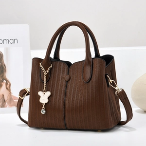 Dark brown textured leather handbag with gold bear charm and detachable strap