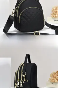 Detail of black quilted mini bag featuring three gold zippers and nylon texture