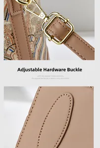Detail of vintage jacquard fabric and golden metal buckle on stylish shoulder bag