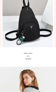 Detail of black nylon shoulder bag with silver V-logo and star pearl pendant charms
