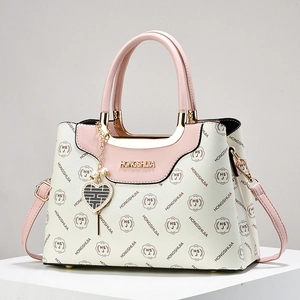 Elegant white and pink patchwork handbag with golden logo and heart charm detail
