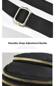 Detail of black quilted bag with gold hardware, metal strap buckle and dual zipper design