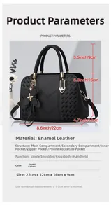 Detail view of black patent leather handbag showing dimensions 22x16cm and bottom studs