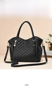 Detail of black quilted shoulder bag featuring classic diamond stitching and metal buckle