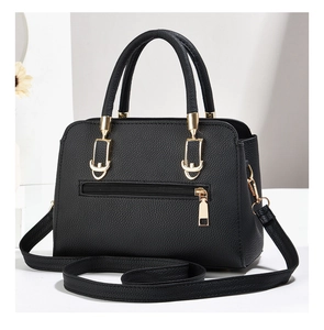 Detail of black pebbled leather tote bag with gold hardware and removable shoulder strap