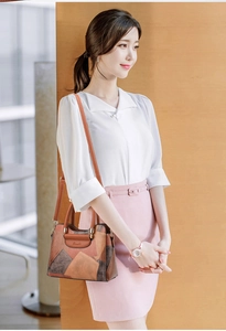 Detail showing the retro patchwork leather texture and metal buckle on women handbag